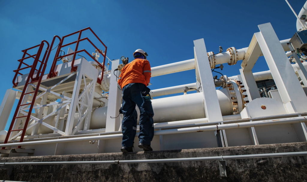 construction worker working on chemical pipe